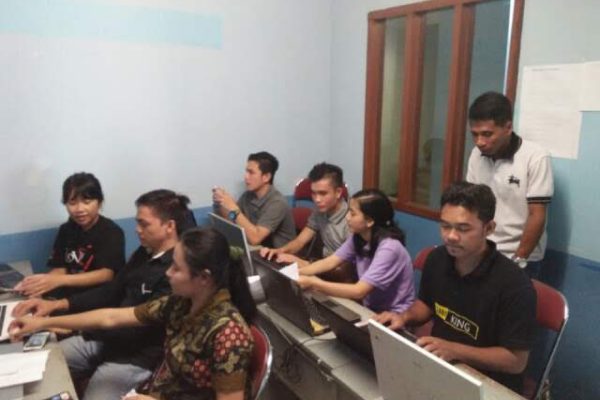 IT Training Center Berilmu — seminarians learning Office 365 and Photoshop computer skills at the training center