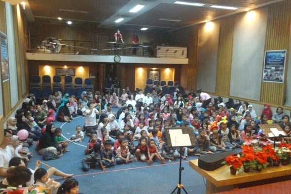 Group of smiling Indonesian children together in a learning program, joyful community setting